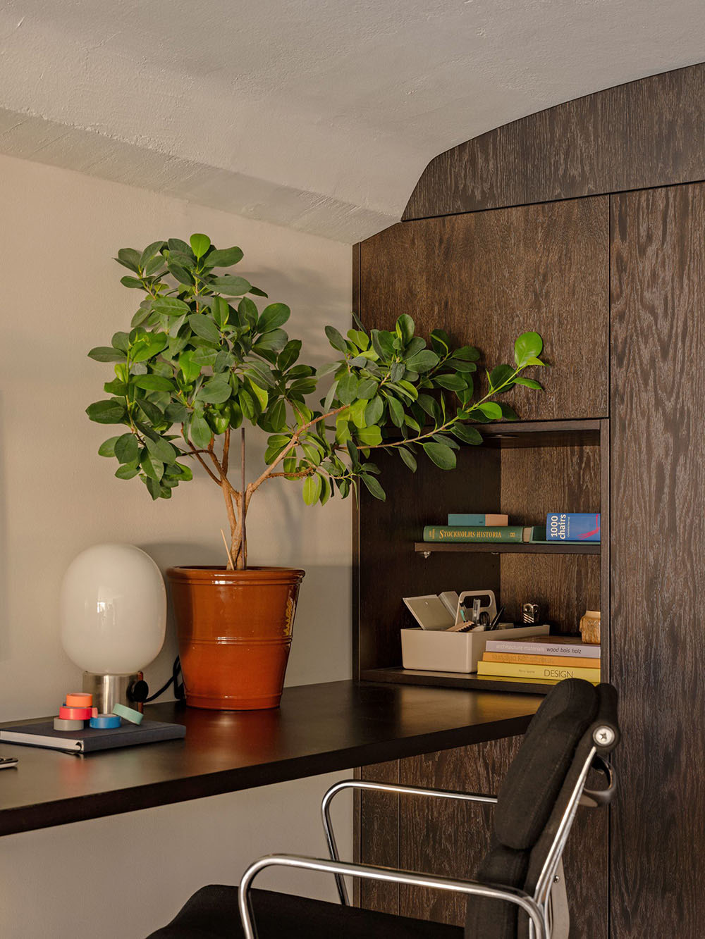 Home office with wooden open shelving and warm wood tones, evoking a moody, textured fall styling mood.