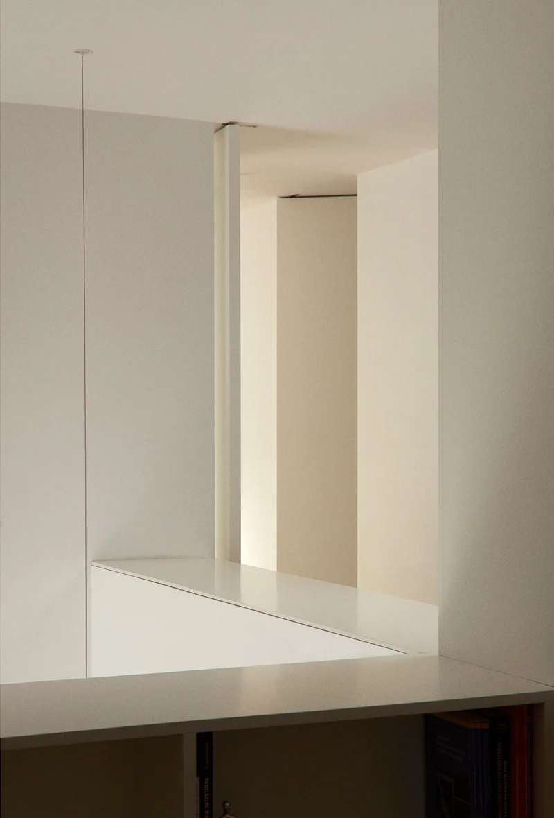 Minimalist interior with flush concrete walls and seamless transitions, showing clean joint-free surfaces throughout.