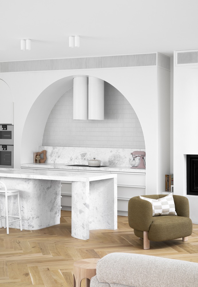 Minimalist white kitchen with marble countertop island, soft edges, and bright open layout.