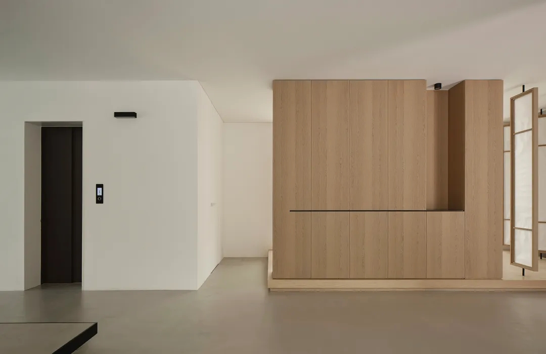 Warm minimalist small apartment with modular storage and compact living zones.
