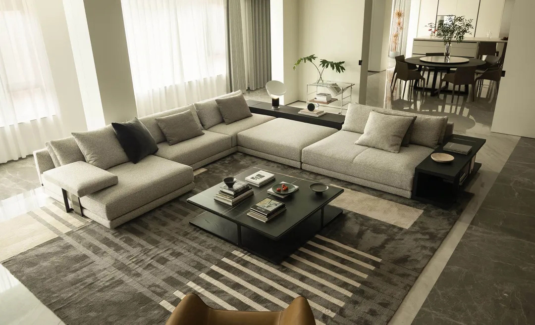 Cozy neutral living room with a gray fabric sofa, light walls, and simple decorative accents.