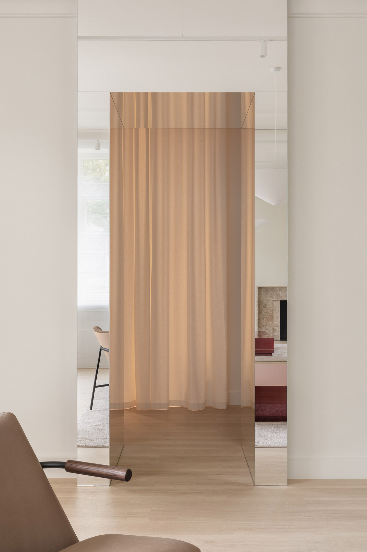 Parisian studio with a soft divider, warm lighting, and minimalist furniture.