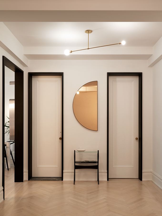 Modern hardwood entryway with neutral finishes and clean architectural lighting.