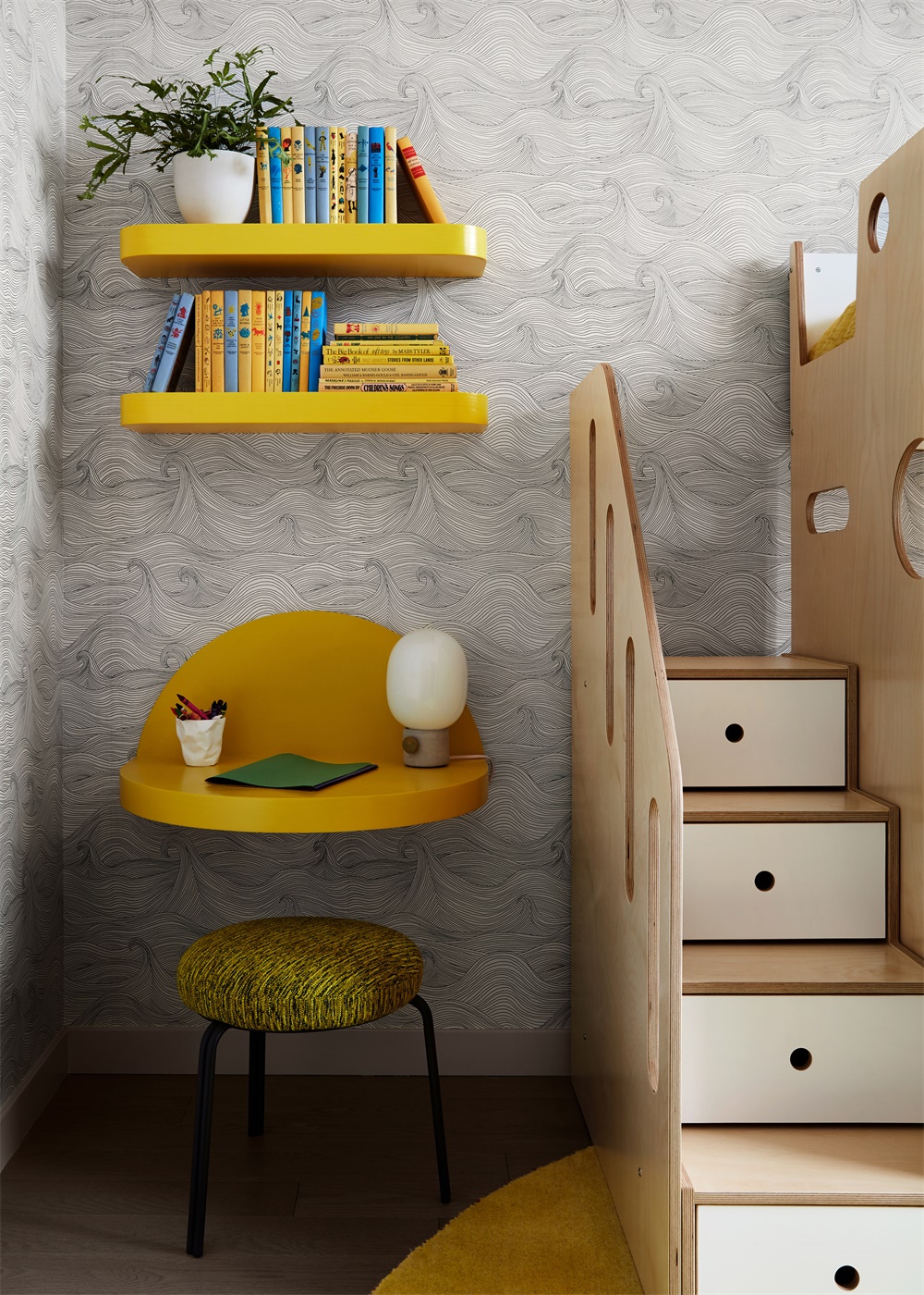 Kids' playroom with yellow open shelving, styled as a compact homework and study nook for children.