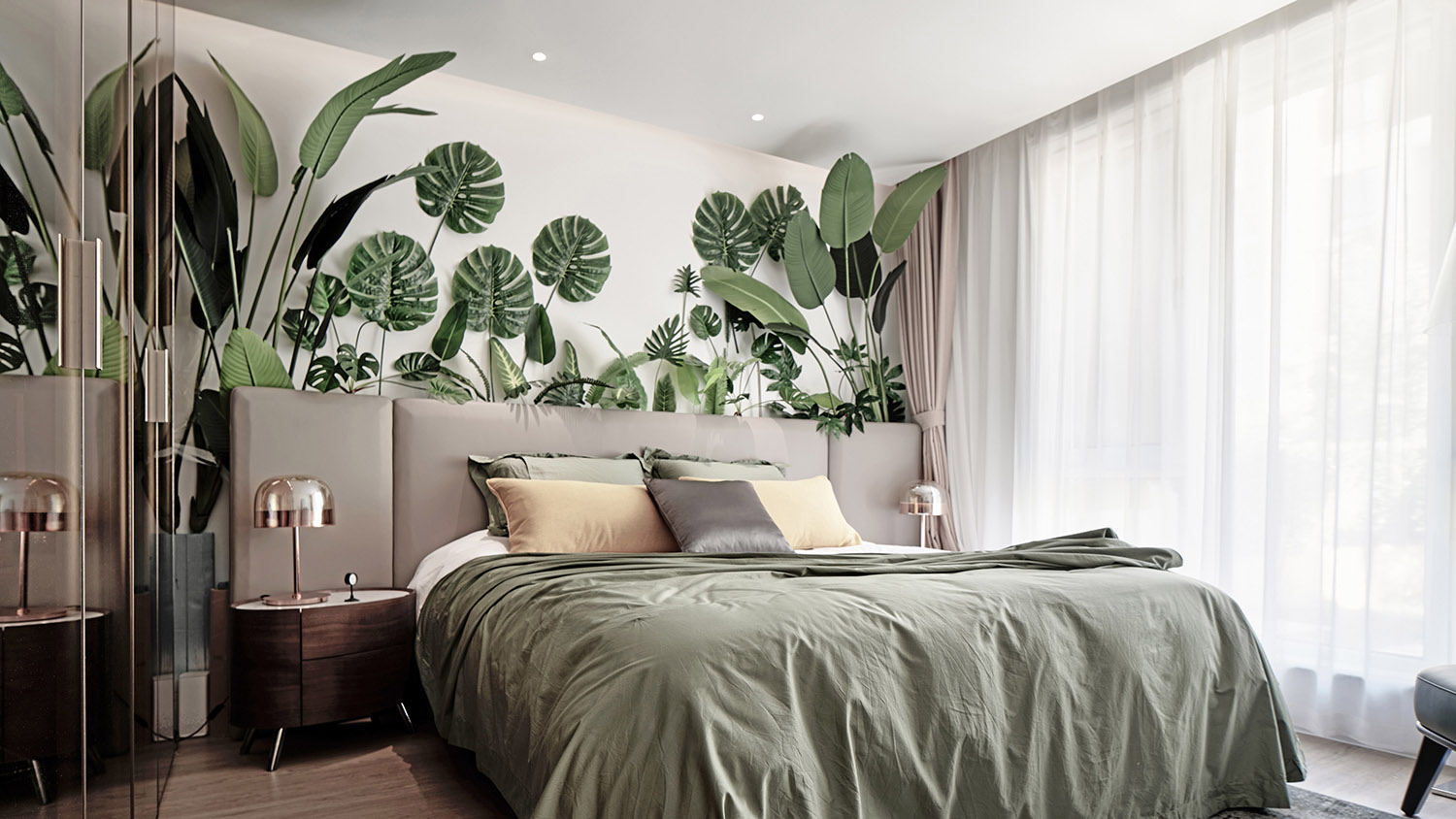 Modern bedroom with green bedding, a living plant wall accent, and minimalist styling for a cool, biophilic atmosphere.