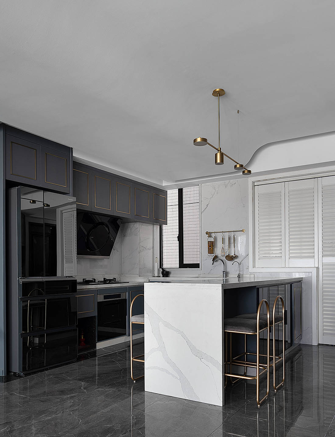 Minimalist galley kitchen with warm white marble countertops and clean cabinetry — a before-and-after remodel reference for small-budget 2026 renovations