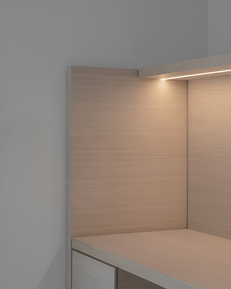Minimalist wood cabinet with integrated ambient lighting for a soft, warm glow.