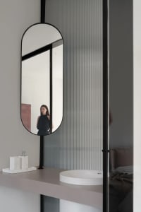 Modern bathroom interior with a glass faucet and minimalist design.
