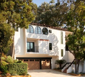 Modern residential building with white concrete and stucco facade.