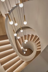 Industrial-style staircase with modern lighting design.