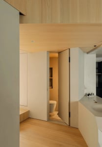 Modern bathroom featuring wooden panels and a concrete surface.