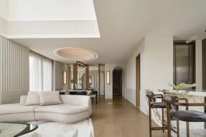 A modern living room featuring marble, wood, and glass materials with a minimalist design.