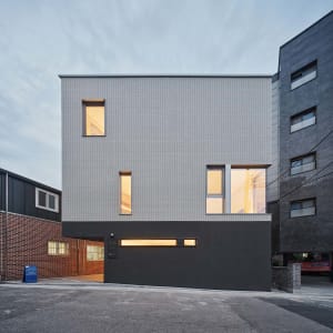 A modern building with a combination of concrete, tile, and brick materials.