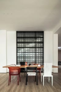 A modern office space featuring a wooden desk with various chairs.