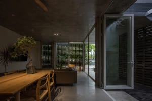 Concrete residential interior with large glass doors and minimalist design.