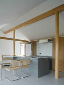 Minimalist kitchen design featuring concrete countertops and wooden elements
