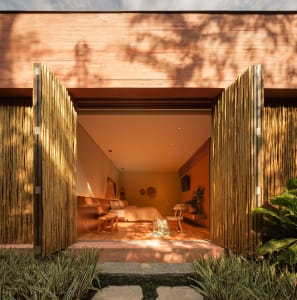 A bohemian-style bedroom with wooden panels made of bamboo.