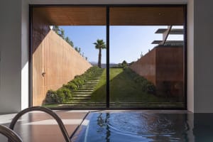 A modern landscape featuring a terraced garden with plants and stairs.