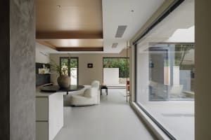 Modern living room with concrete floors and glass elements