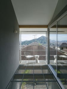 Modern interior design with metal furniture and a view of mountains through a glass wall.