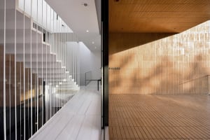 A modern interior featuring wooden tiles and stairs.
