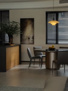 Modern dining room with metal, marble, and leather elements