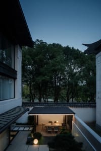 Modern residential dining space featuring wood elements and ambient lighting.