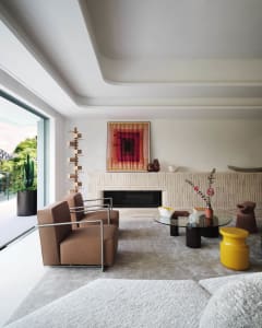 A modern living room featuring neutral-toned furniture and minimalistic decor.