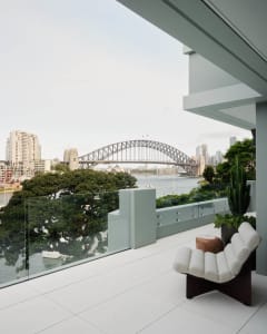A modern balcony overlooking the city with glass railings.