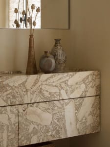 Modern marble console table with artisanal ceramic vases and dried flowers
