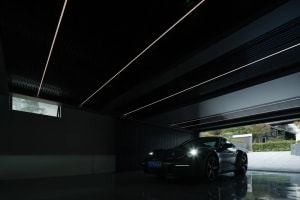 A sleek, metallic modern garage interior with a reflective floor and contemporary design elements.