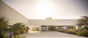 Modern residential exterior with minimalist design and concrete materials.