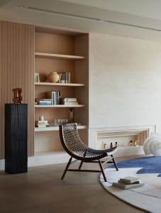 A modern residential interior featuring wood, leather, and ceramic elements.