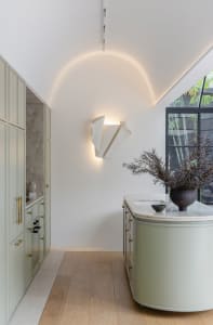 Modern residential kitchen with marble countertops and minimalist design.