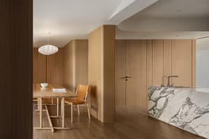 Modern kitchen featuring marble countertops, stainless steel appliances, and wooden cabinets