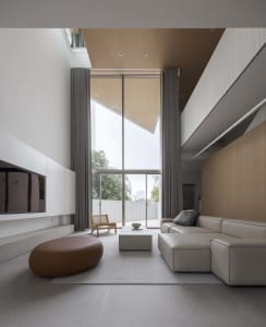 A modern living room with concrete flooring and minimalist design features.