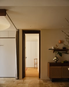 A minimalist kitchen with wooden cabinets and flooring