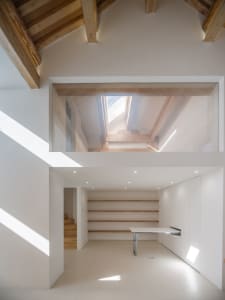A minimalist interior with white walls and wooden accents.