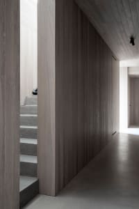 A modern interior space featuring concrete walls