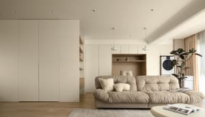 Neutral-tones minimalist living room with built-in storage and comfortable seating.
