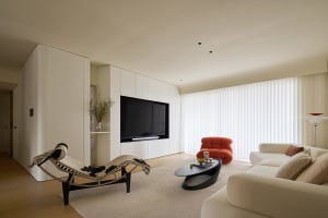 Modern living room with white furniture, minimalistic design, and a large window with roller blinds.