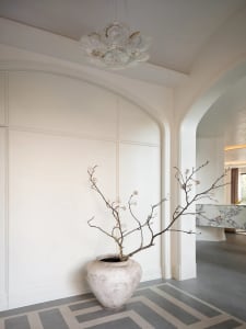 Modern lobby interior with white walls, concrete flooring, and a marble reception counter