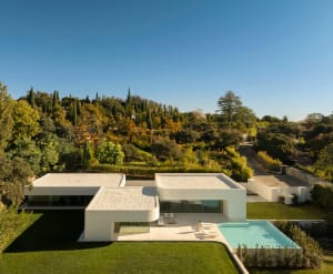 Modern residential home featuring glass, concrete, and stone materials.