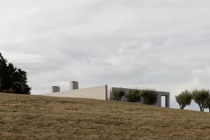 A modern building constructed with concrete materials, featuring a minimalist design.