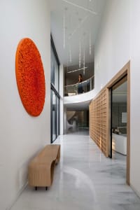 A modern residential corridor featuring white marble floors.