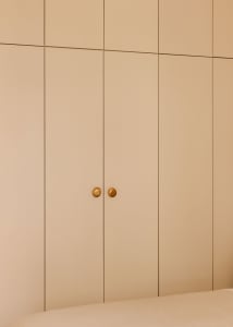 A modern, minimalist wardrobe with neutral colors and simple, elegant design.