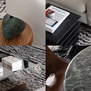 A modern interior coffee table with a metallic vase, books, and marble material.