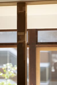 A close-up view of a modern interior designed with a wooden column as a central structural element.