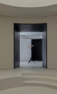 Minimalist showroom interior with metallic lighting fixture.