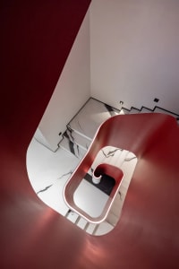 Modern interior with marble stairs, white walls, and black accents.